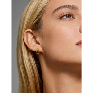 Minimalist wide gold hoop earring in S925 sterling silver worn on a female model