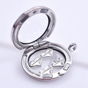 Macro view of silver locket with heart-shaped grandpa charms inside on white background