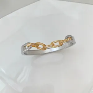 French style silver and gold C-shaped cuff bracelet with pavé-set cubic zirconia rings