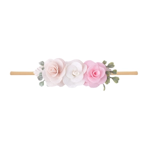 Detail of pink fabric flowers and green leaves on a soft elastic baby headband