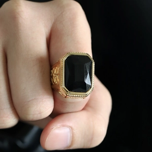 Gold stainless steel men's ring with large rectangular black gemstone and ornate carvings