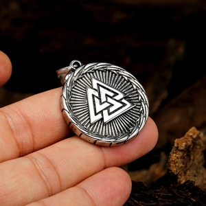 Men's Nordic Valknut pendant necklace with Viking runes on a wood background