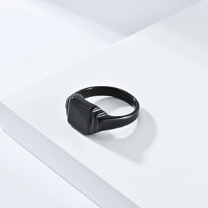 Macro shot of minimalist square black titanium steel ring on white steps