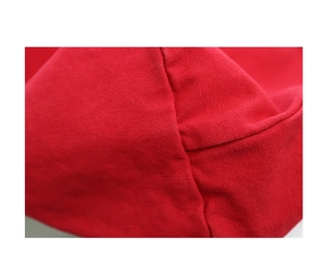 Close-up of red washed canvas texture and reinforced stitching on this vintage bag