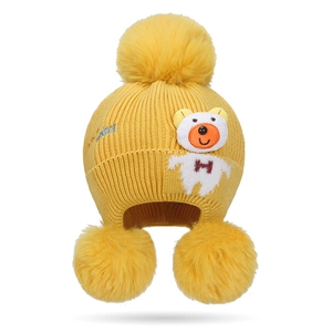 Bright yellow infant earflap knit hat with three faux fur pom-poms and cute bear embroidery