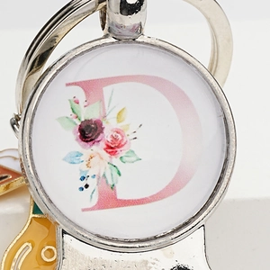 Custom silver keychain with floral letter D pendant in a creative round glass cabochon