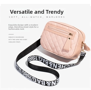 Pink quilted crossbody bag detail showing classic diamond stitching and wide woven strap