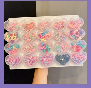 Detailed set of 20 heart-shaped boxes with colorful macaron hair ties and floral clips