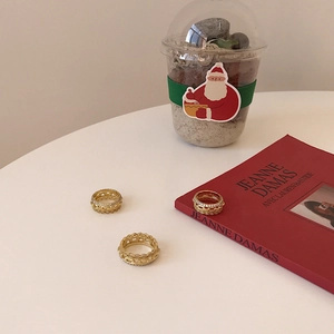 Close-up of golden S925 silver rings with zircon chains on a cozy desktop background