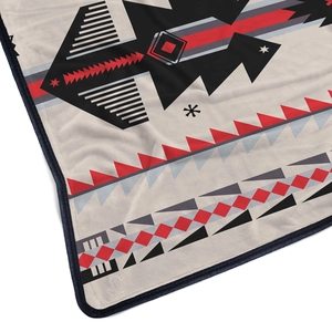 Detail shot of southwest tribal flannel blanket with star patterns and blue edges