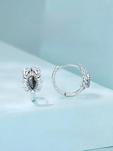 Detailed close-up of retro S925 silver scorpion earrings with dark teardrop gemstones