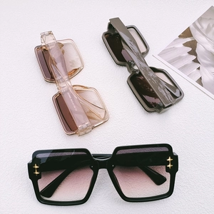 Three square sunglasses with gold cross star details on textured white background