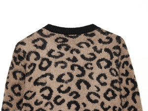 Close-up of leopard jacquard knit cardigan with soft fuzzy texture and ribbed crewneck