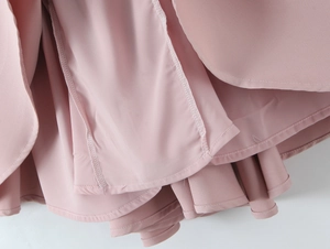 Close-up of the double-layered hem stitching on this dusty pink pleated dress fabric