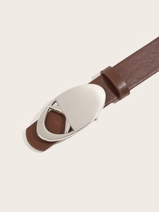 Detail of a brown leather belt featuring a sleek silver heart-shaped metal buckle