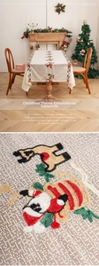 Close-up of festive Santa and reindeer embroidery on premium textured Christmas tablecloth