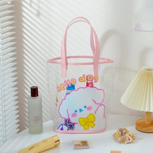 Detail view of pink transparent PVC tote bag with cute dog print on a sunlit table