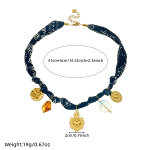 Vintage beaded necklace with blue paisley fabric, gold heart and floral embossed charms