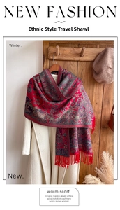 Close-up of red ethnic paisley shawl with fringe details and soft cashmere texture
