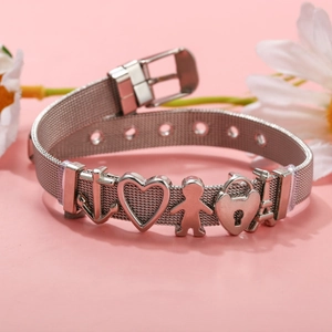 Adjustable silver mesh bracelet with DIY heart and Eiffel Tower charms on pink background