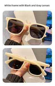 Detalle de gafas de sol cuadradas blanco crema con lentes gris oscuro y remaches