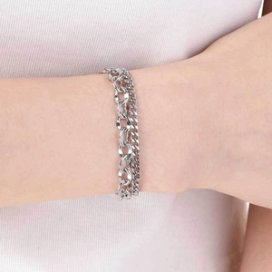 Detail of silver stainless steel double-layered Cuban chain and link bracelet on wrist