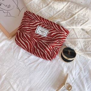 Retro red zebra pattern chenille canvas clutch bag with Time To Party tag on bed