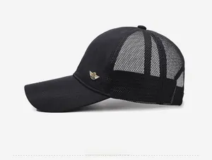 Detail of a black mesh baseball cap showing the gold wing logo and breathable mesh panels
