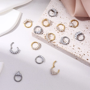 Titanium hinged segment ring with sparkling zircon in gold and silver finishes