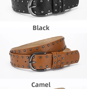 Detail view of punk style leather belts with round metal studs in black and camel colors