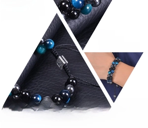 Detailed macro view of triple protection bracelet with tiger eye beads and tree charm