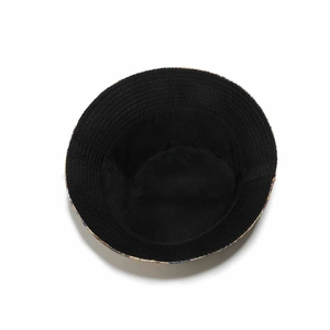 Internal view of a black cotton bucket hat showing fabric texture and printed brim edge