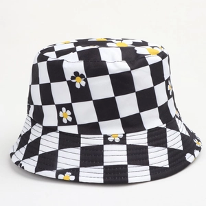 Detail of checkered bucket hat with daisy print showing cotton canvas texture