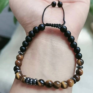 Wrist shot of Mother Daughter Morse code bracelet with tiger eye beads and braided cord