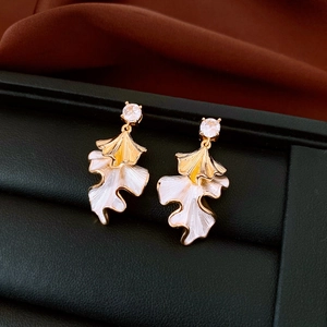 Detail shot of ginkgo leaf earrings with gold plating and cubic zirconia inlay