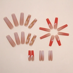 Matte autumn orange long coffin press-on nails with floral art and gold foil accents