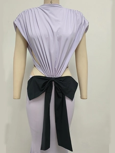 Detail of light purple sleeveless dress featuring a back waist cutout and large black bow