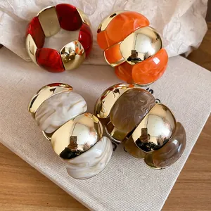 Acrylic marble resin and metal stretch bracelets in red, orange, and white marbling