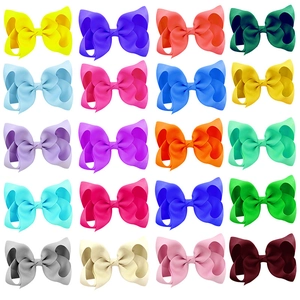 Detailed flat lay of 20 assorted colorful 4-inch grosgrain ribbon bows for girls