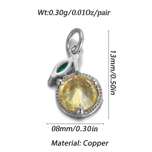 Macro shot of 14k copper lemon pendant with yellow pear-shaped stone and green leaf detail
