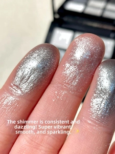 Macro shot of shimmering silver glitter eyeshadow on fingertip with high metallic shine