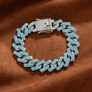 Detail of 15mm silver Cuban link chain with light blue rhinestones on brown fabric