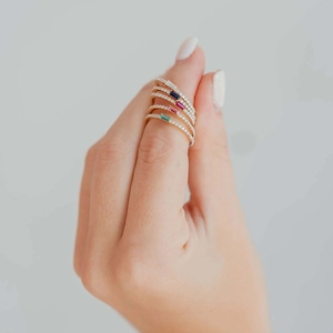 Macro view of gold-plated S925 silver ring featuring rectangular white blue red and green gems