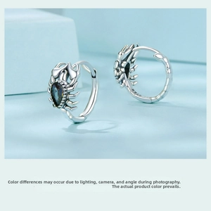 Detailed macro view of S925 sterling silver scorpion earrings with dark gemstone inlay