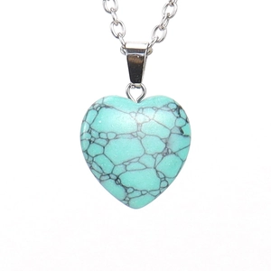 Detailed close-up of heart-shaped turquoise stone pendant with black matrix texture