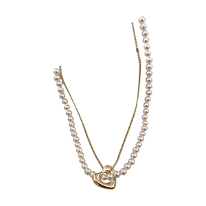 Minimalist double-layer necklace with gold hollow heart pendant and white pearls