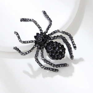 Detailed view of retro spider brooch featuring black rhinestones and gunmetal alloy finish