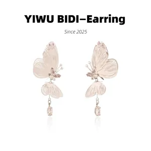 Detail of silver wire butterfly earrings with pink crystals and teardrop pendant charm