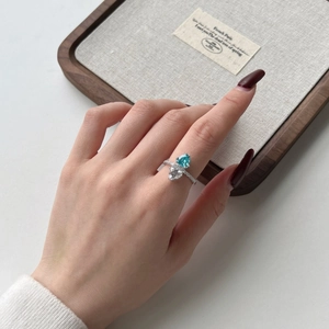Close-up of S925 silver ring featuring blue and white pear-cut zircon stones