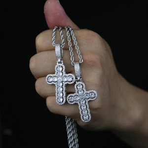 Close-up of sparkling silver hollow cross pendants with cubic zirconia on rope chains